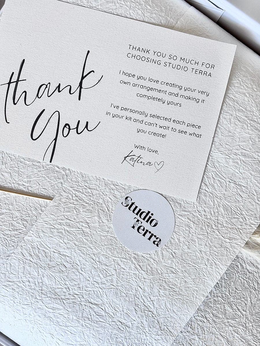 A handwritten style thank you card from Katina, beside a Studio Terra sticker